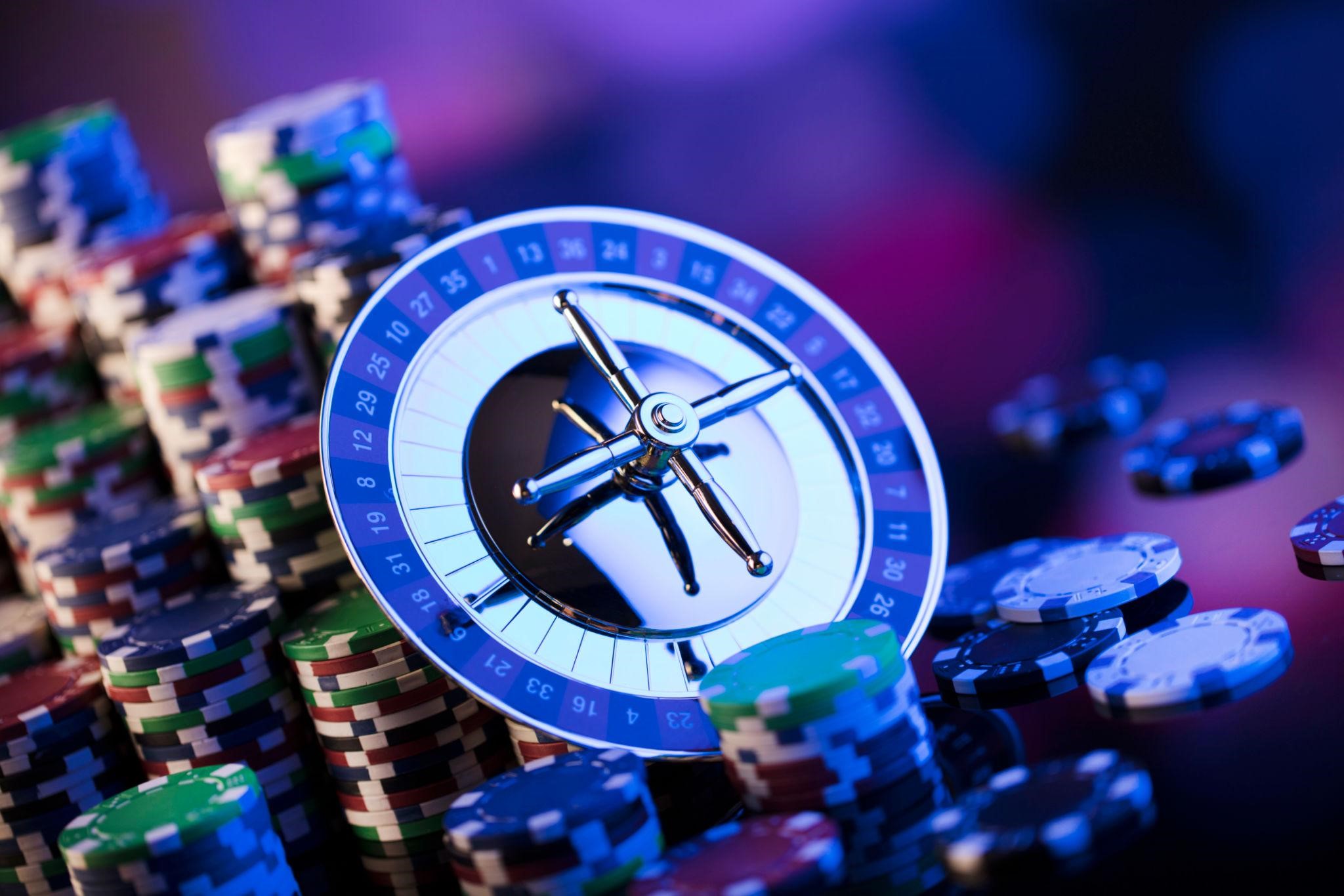 roulette wheel surrounded by colorful casino chips