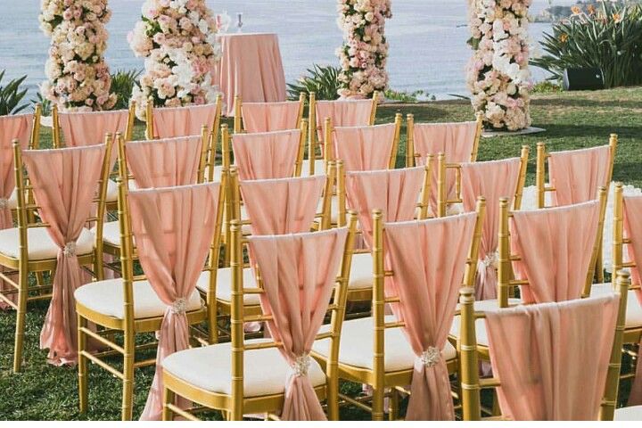 Gold Chiavari chairs placed around decorated banquet tables at a luxury Asian wedding reception venue